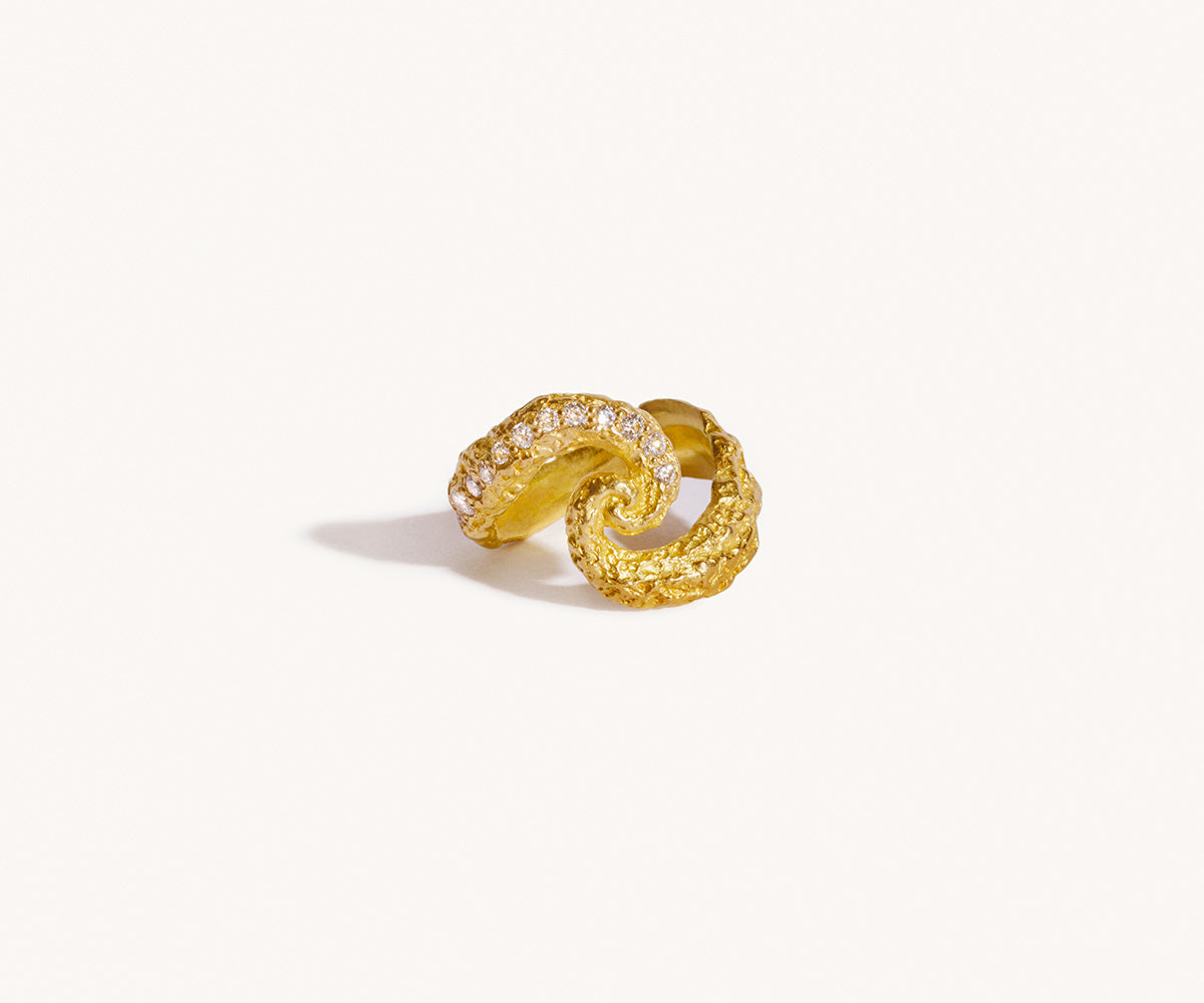A cosmos-inspired ring with 21 diamonds, featuring gold textured like meteorite impacts, with craters filled with precious stones, set against a white background.