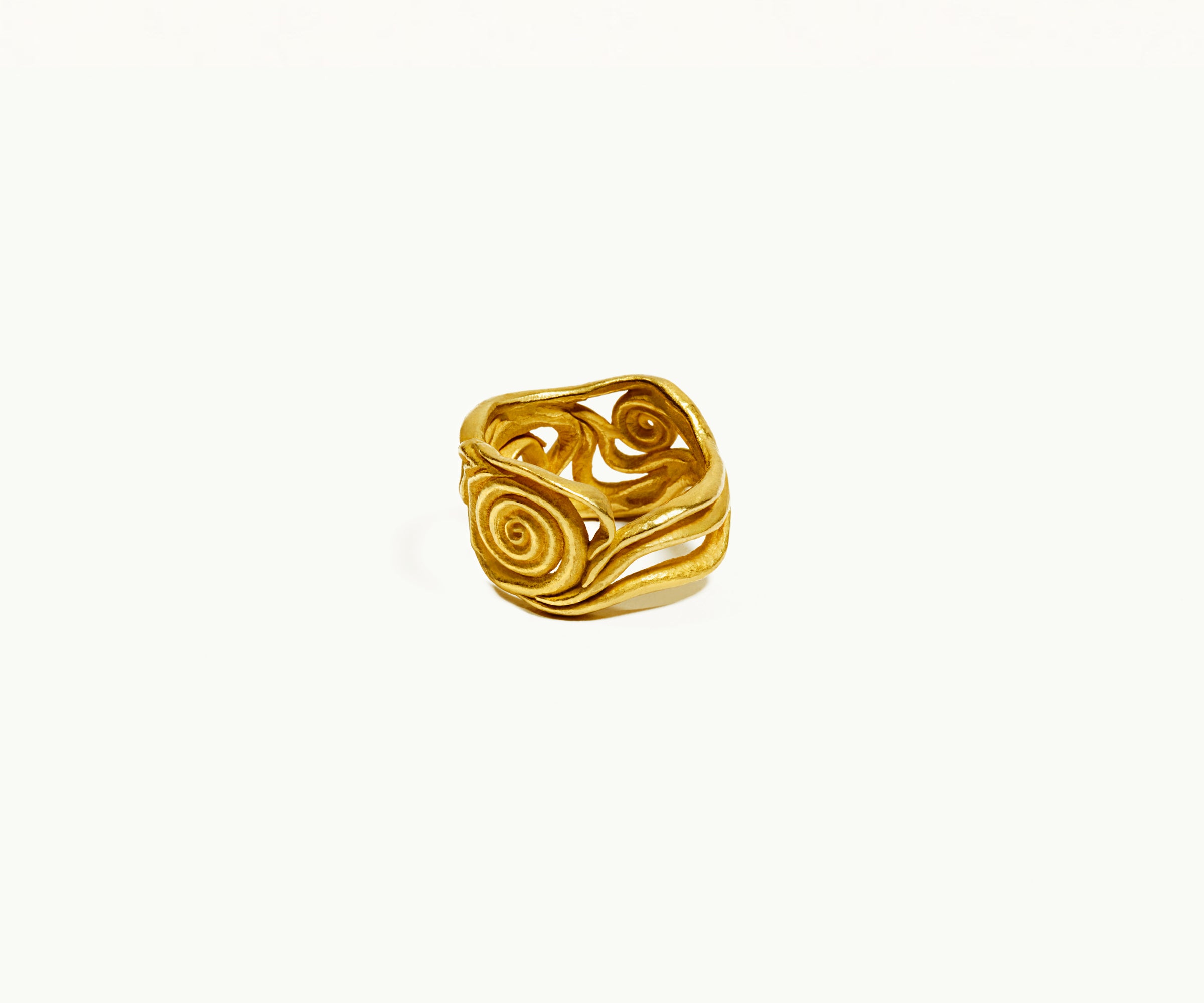 An 18K yellow gold ring shaped organically, inspired by nature. The center part resembles a spiral.
